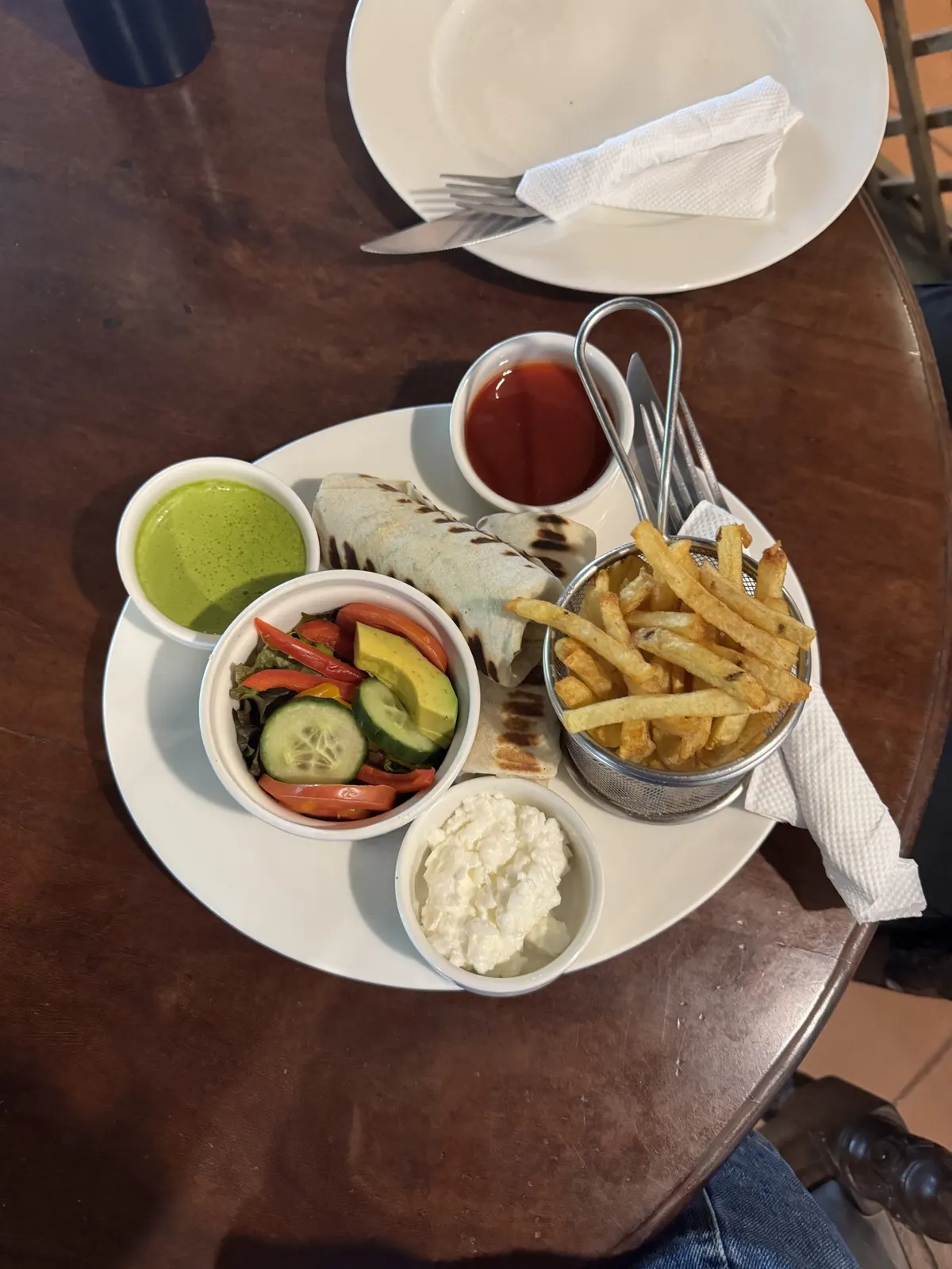 A tortilla wrap served with chips and dips